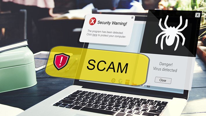 Laptop showing scam warning and fake alert pop-up indicating online fraud imei